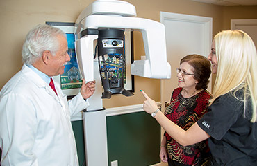 Dr. levine and assistant with patient at CT machine